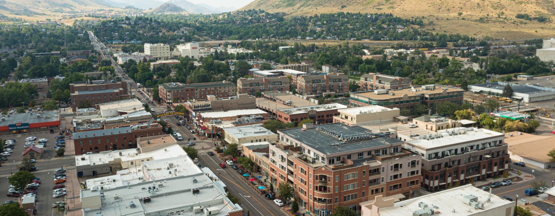 a city with many buildings and hills in the background